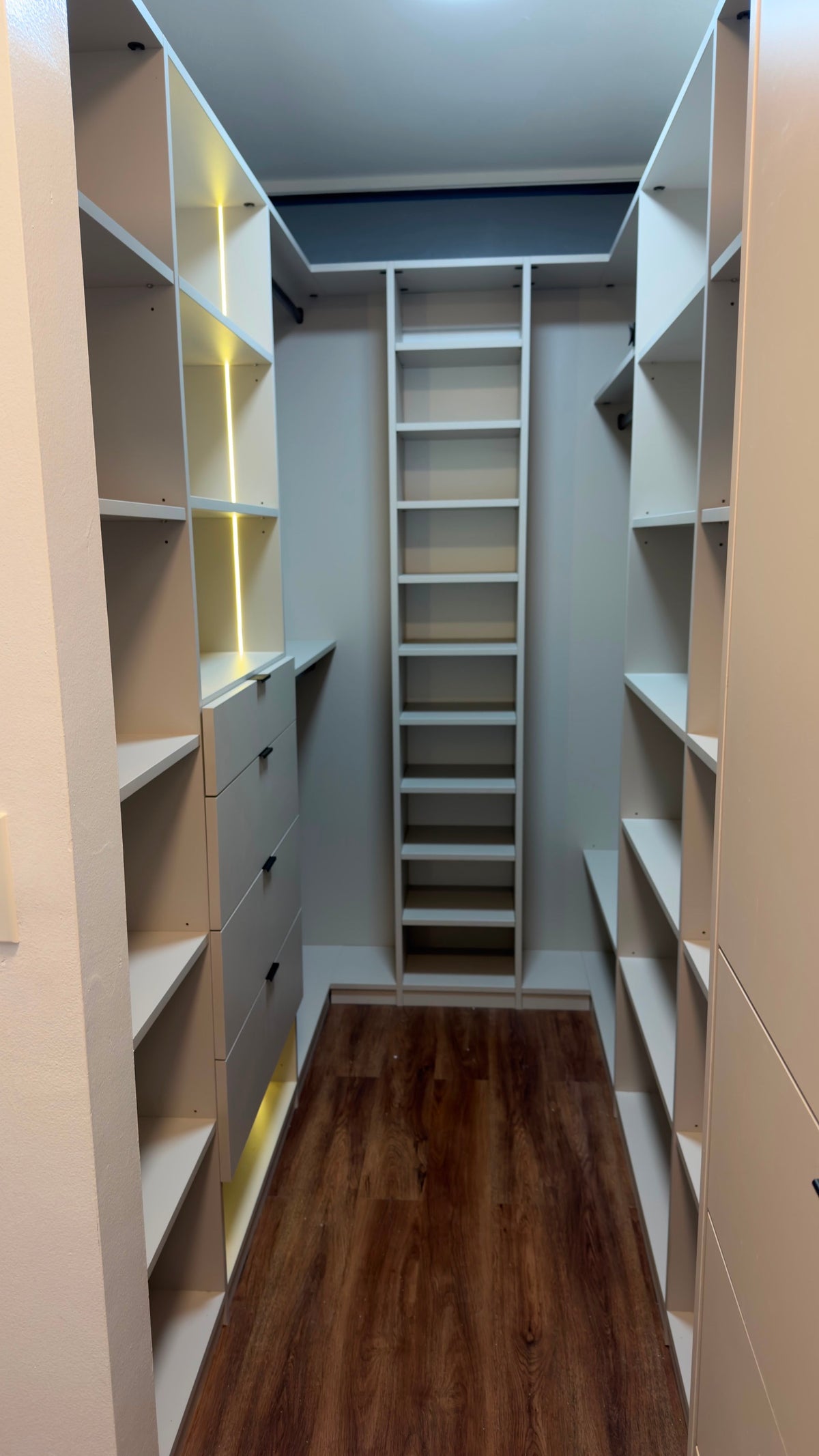 Custom walk-in closet in Cashmere Grey with LED lighting, drawers and shoe tower